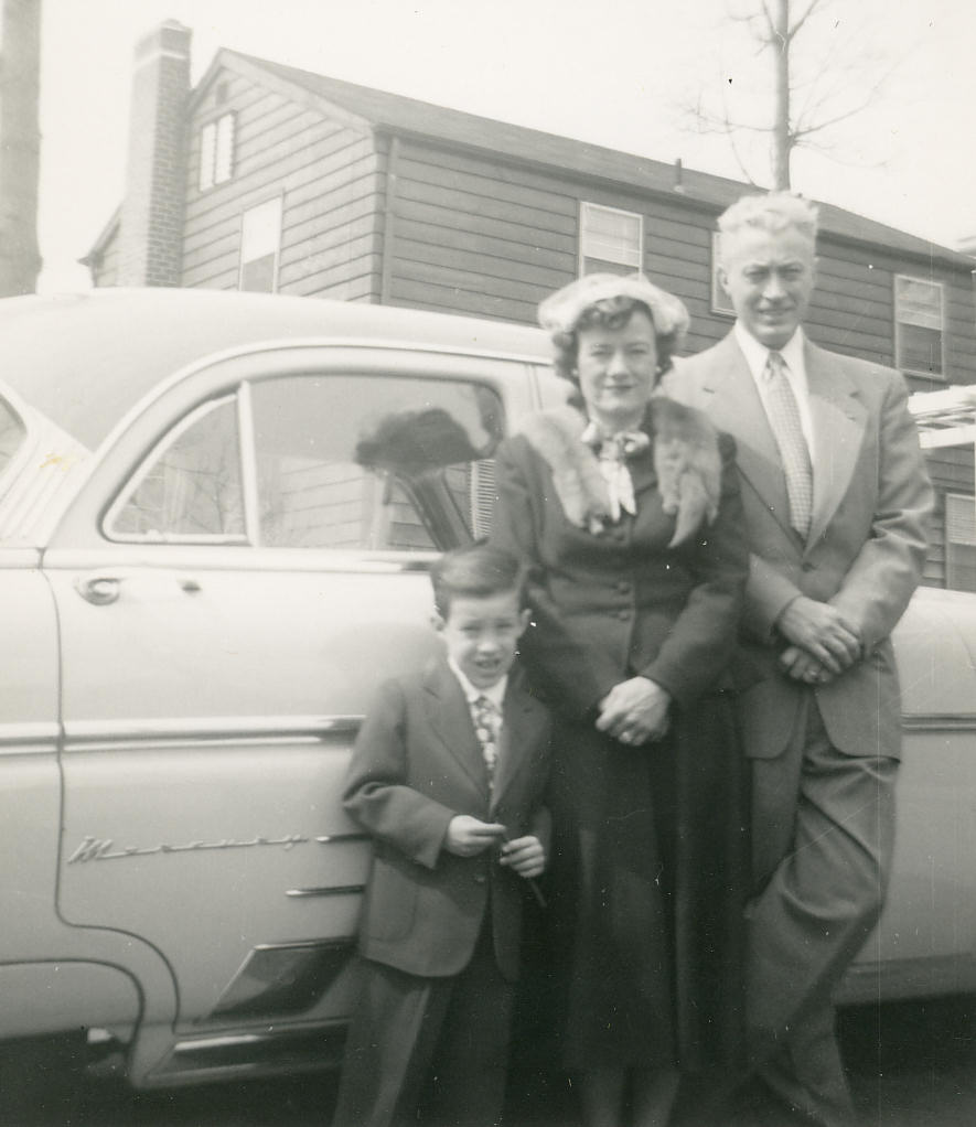 Ricky, Mom and Dad in front of our 1948 Ford Mercury, 1954.